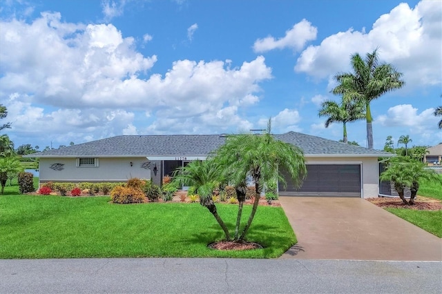 single story home featuring a garage and a front lawn