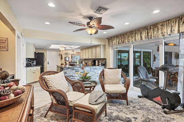 living room with light hardwood / wood-style floors and ceiling fan