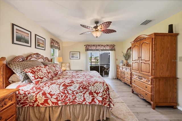 bedroom featuring access to outside, light hardwood / wood-style floors, and ceiling fan