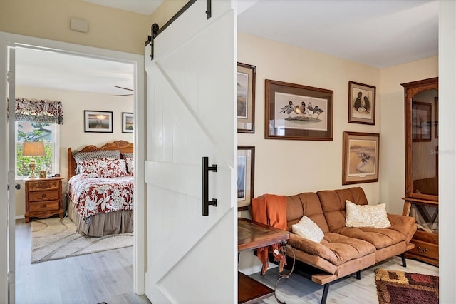 bedroom featuring light hardwood / wood-style floors and a barn door