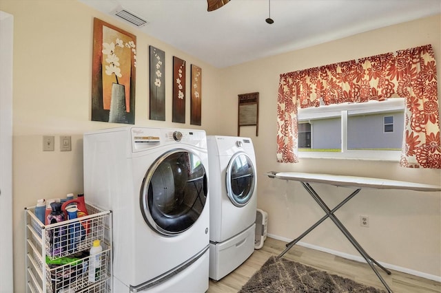 laundry area featuring washer and clothes dryer and hardwood / wood-style floors