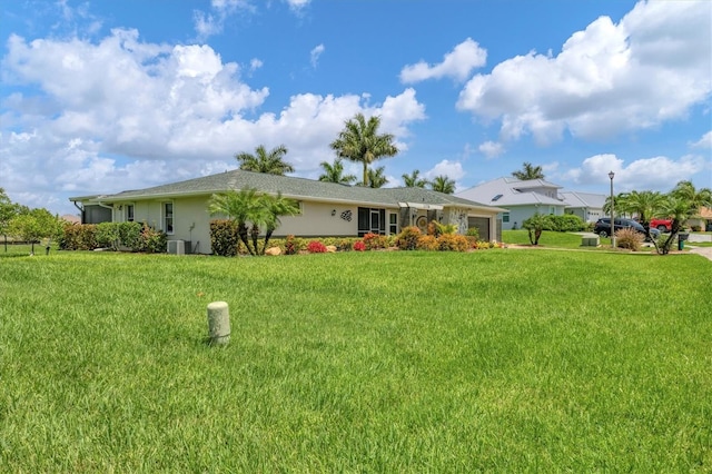 exterior space featuring a front lawn and central air condition unit