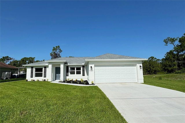 view of front of property featuring a garage and a front lawn