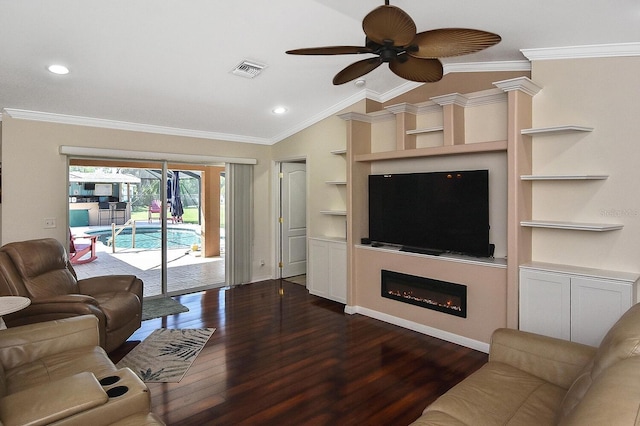 living room with ceiling fan, built in shelves, dark hardwood / wood-style flooring, ornamental molding, and lofted ceiling