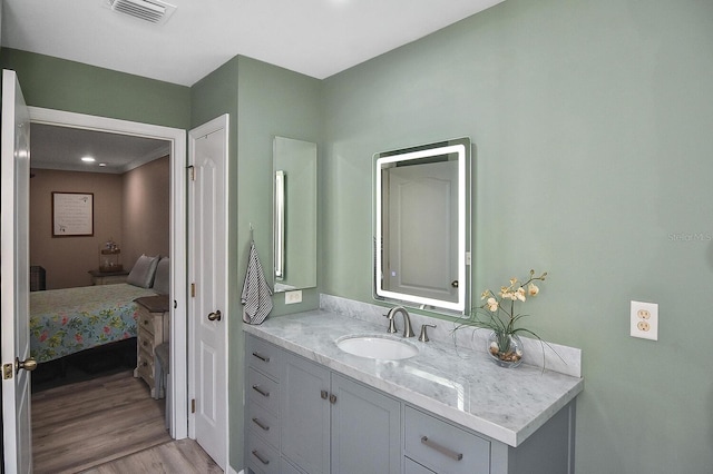 bathroom with vanity and hardwood / wood-style floors