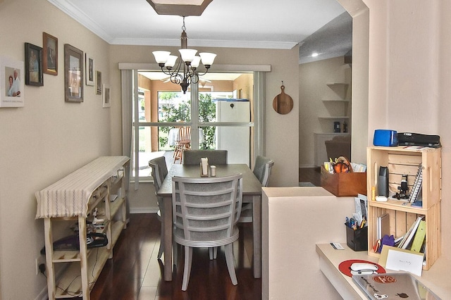 dining area with an inviting chandelier, dark hardwood / wood-style floors, and ornamental molding