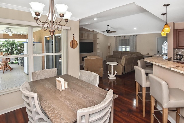 dining area featuring ceiling fan with notable chandelier, dark hardwood / wood-style flooring, and ornamental molding