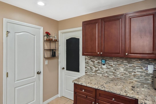 kitchen with light tile patterned flooring, tasteful backsplash, and light stone countertops