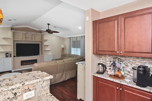 kitchen featuring ceiling fan, decorative backsplash, ornamental molding, vaulted ceiling, and dark wood-type flooring