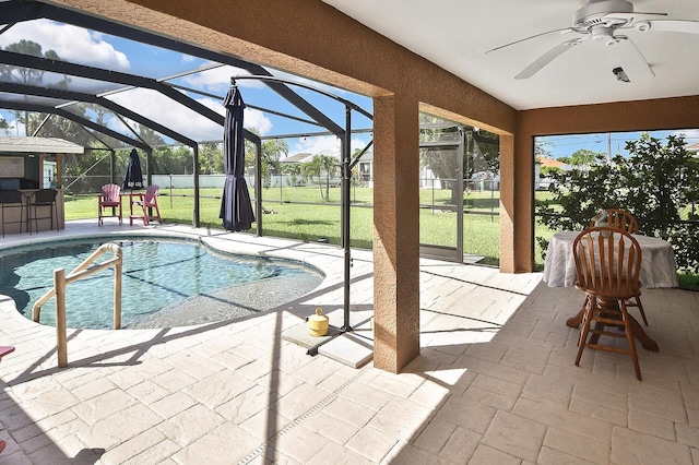 view of pool with a yard, a patio, a lanai, and ceiling fan