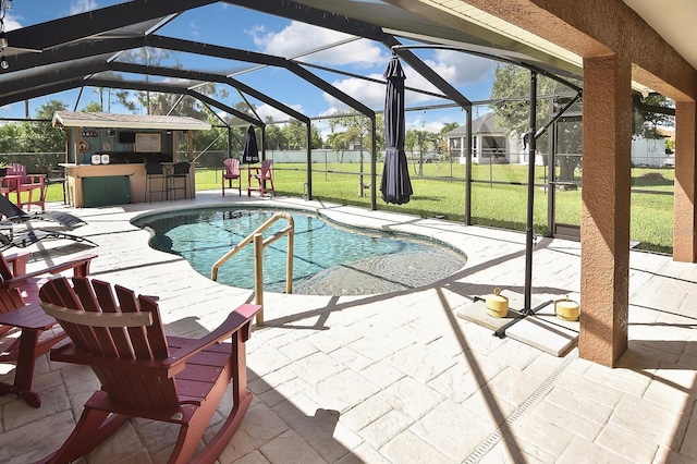 view of swimming pool with a patio, glass enclosure, and a yard