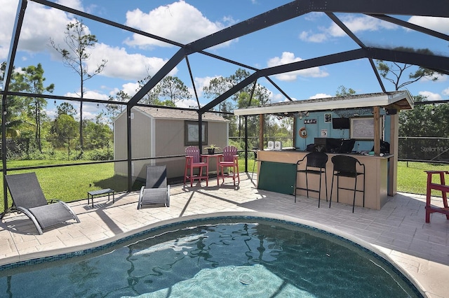 view of swimming pool with a patio area, a bar, and glass enclosure