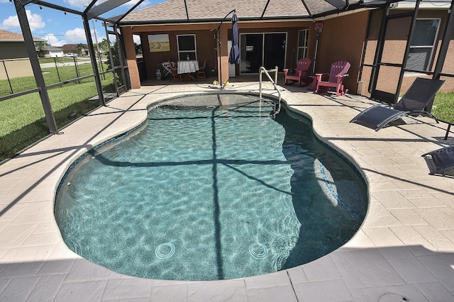 view of pool featuring a patio, glass enclosure, and a yard