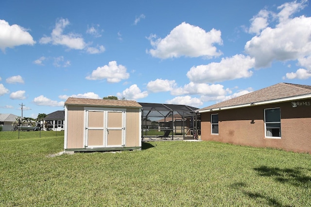 view of yard with a storage shed and a lanai