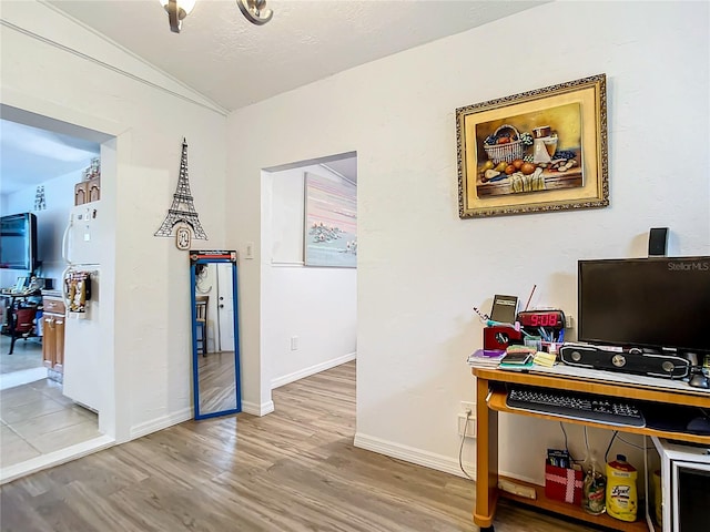 office space with wood-type flooring and vaulted ceiling