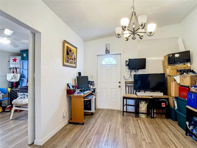 office space featuring wood-type flooring and ceiling fan with notable chandelier