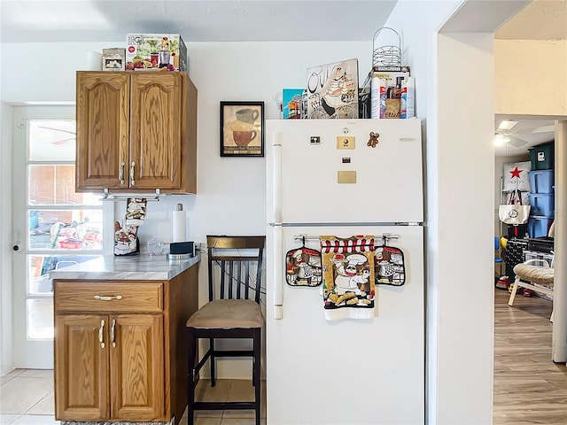 kitchen featuring light tile patterned floors and white refrigerator