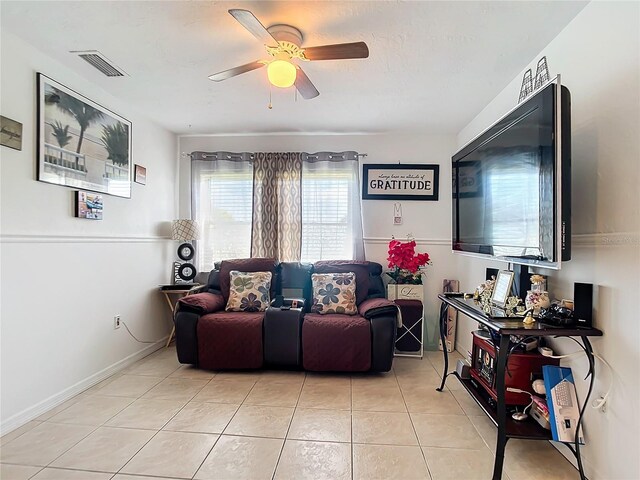 tiled living room with ceiling fan