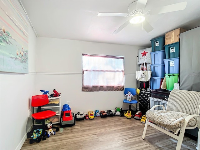 rec room featuring light wood-type flooring and ceiling fan