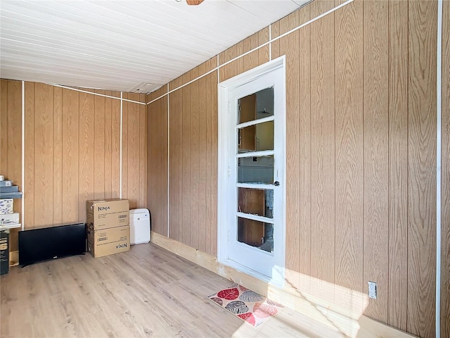 exterior space featuring light hardwood / wood-style floors and wood walls