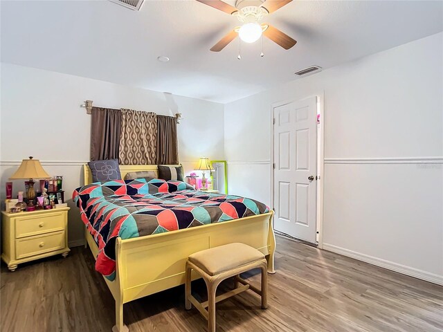 bedroom with ceiling fan and hardwood / wood-style flooring