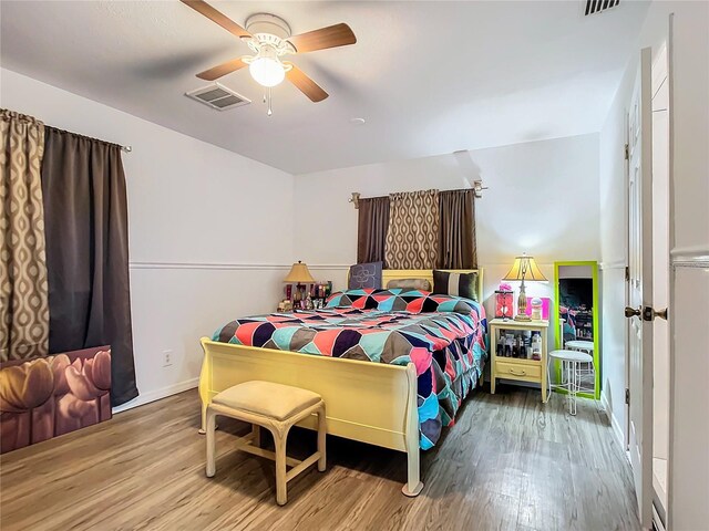 bedroom featuring hardwood / wood-style floors and ceiling fan