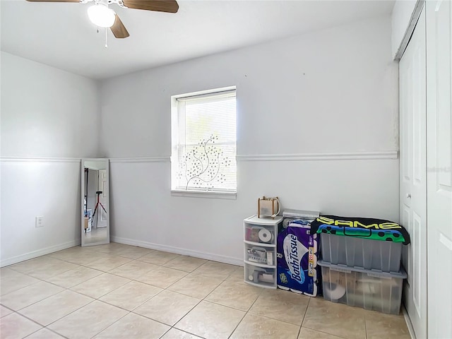 tiled bedroom with a closet and ceiling fan