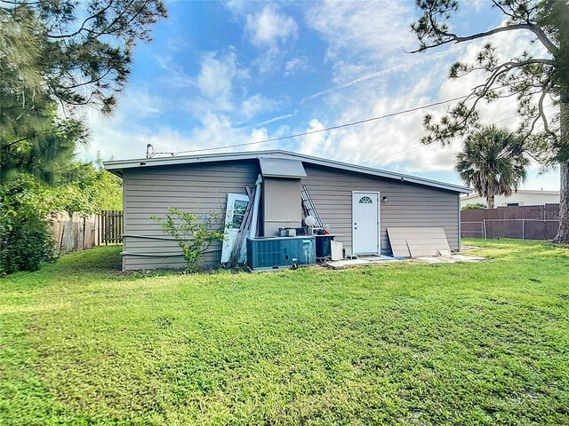 rear view of property featuring a yard