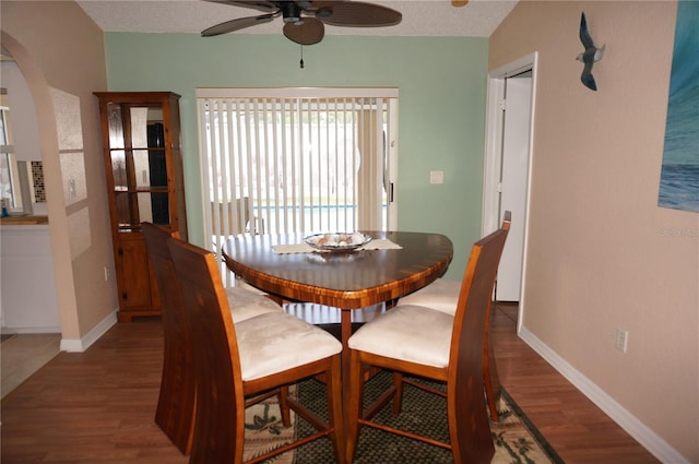 dining room featuring hardwood / wood-style flooring, a textured ceiling, and ceiling fan