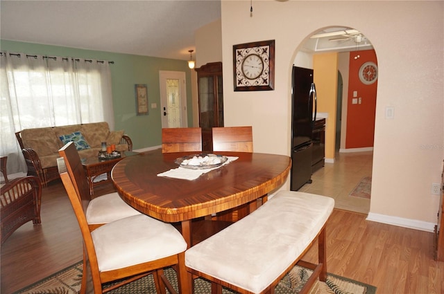 dining space featuring light wood-type flooring and ceiling fan