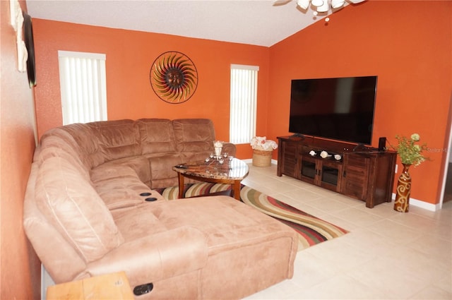 tiled living room with ceiling fan and lofted ceiling