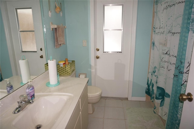 bathroom featuring tile patterned floors, toilet, and vanity