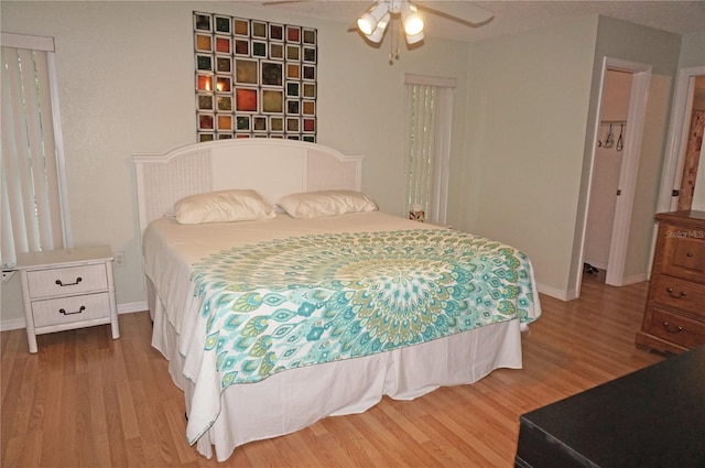 bedroom with ceiling fan and hardwood / wood-style floors