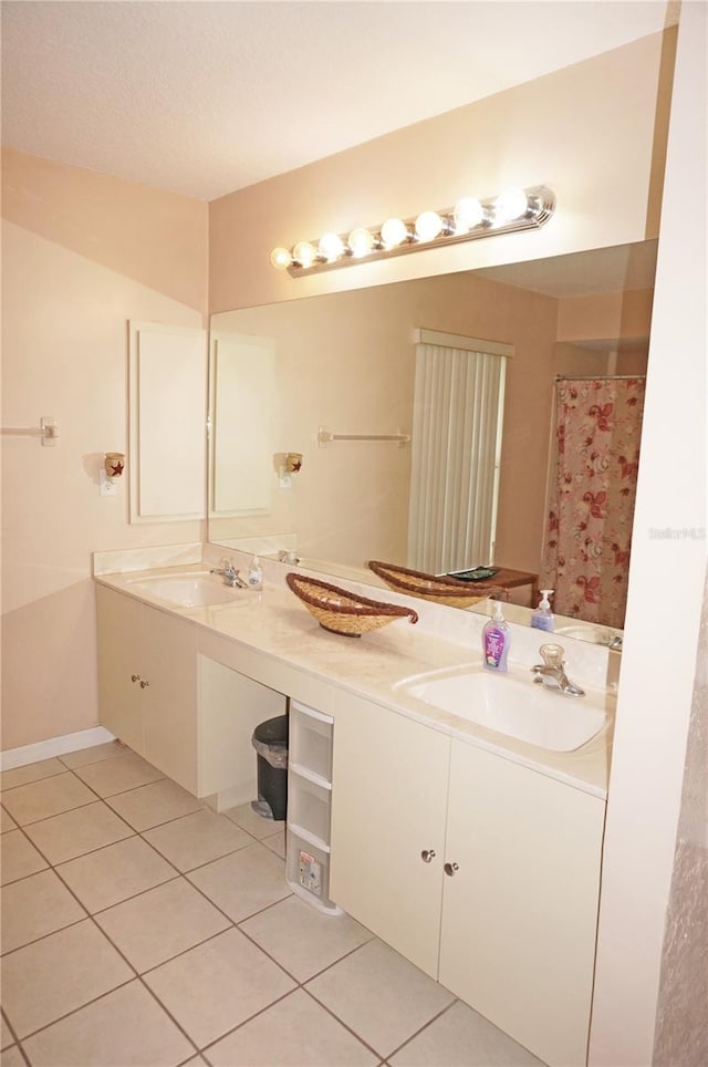 bathroom featuring tile patterned flooring and dual bowl vanity