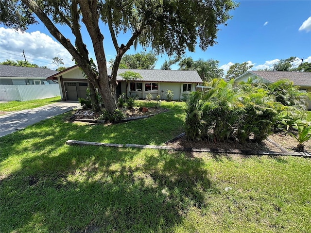 ranch-style house featuring a garage and a front lawn