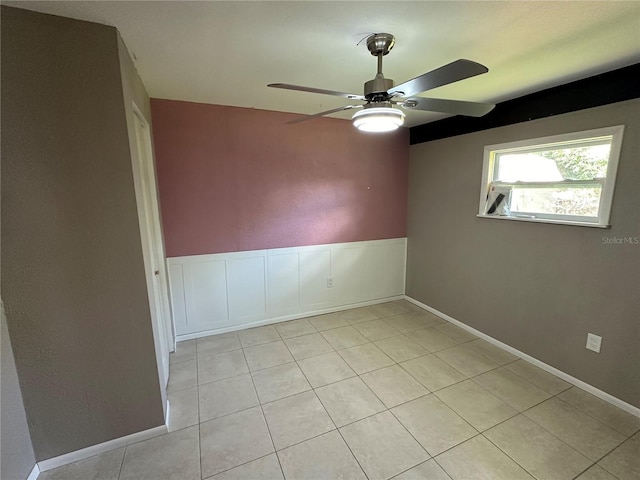 unfurnished room with light tile patterned flooring and ceiling fan