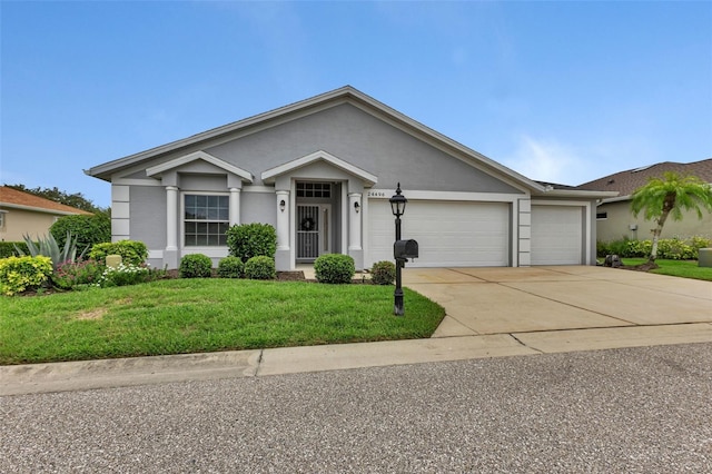 single story home with a garage and a front lawn