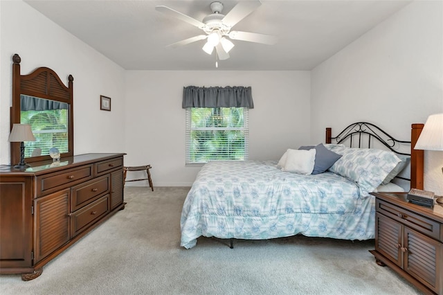 bedroom with ceiling fan and light carpet