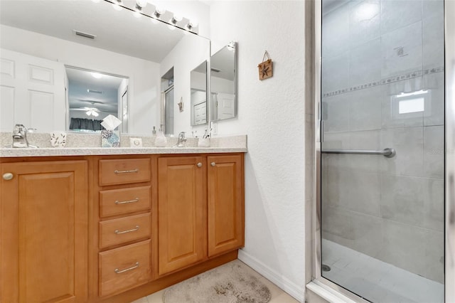 bathroom with vanity and a shower with shower door