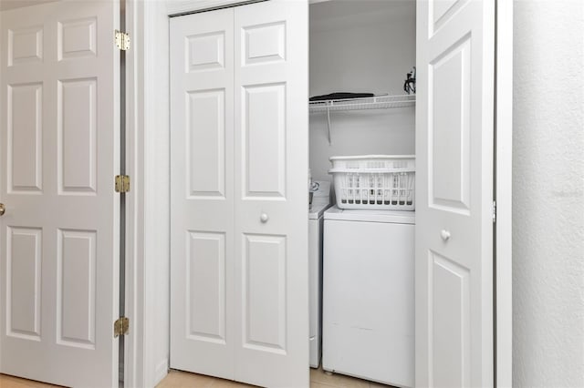 clothes washing area featuring light tile patterned floors and washer / dryer