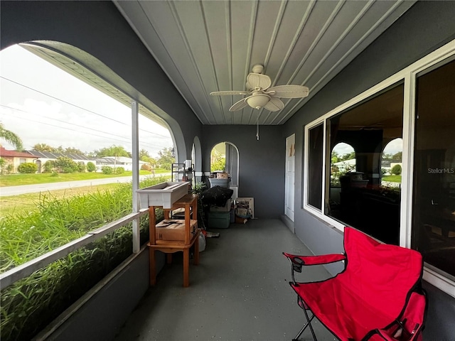 sunroom / solarium featuring ceiling fan