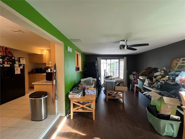 living room featuring ceiling fan and light hardwood / wood-style flooring