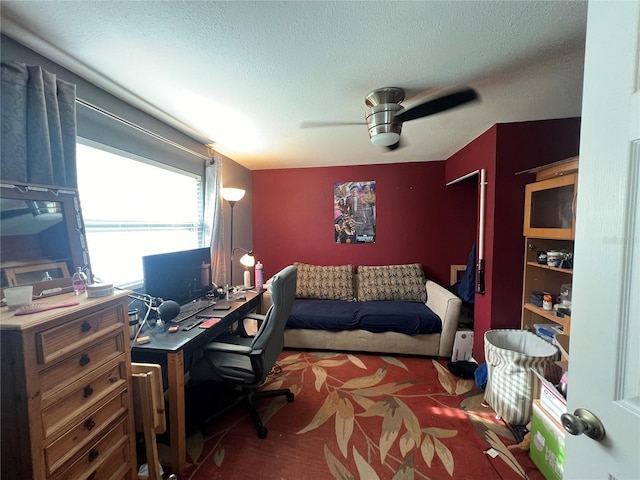 home office with a textured ceiling and ceiling fan