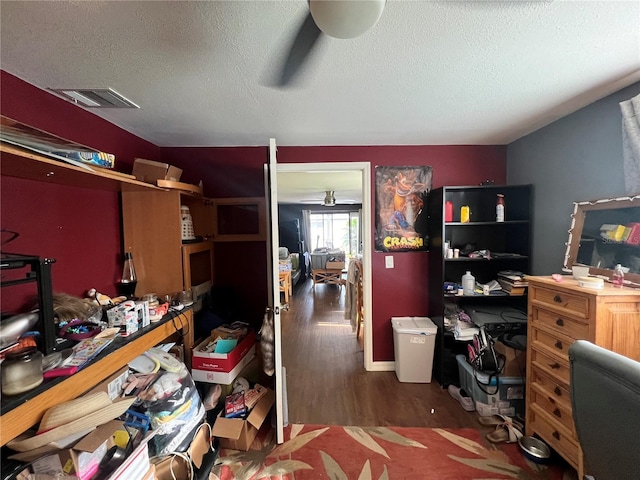 office area featuring dark hardwood / wood-style flooring, a textured ceiling, and ceiling fan