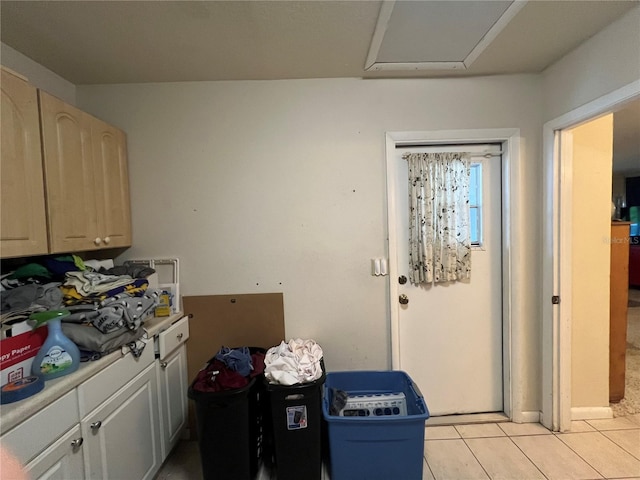 kitchen with light brown cabinets and light tile patterned flooring