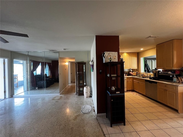 kitchen with sink, ceiling fan, dishwasher, and light brown cabinets