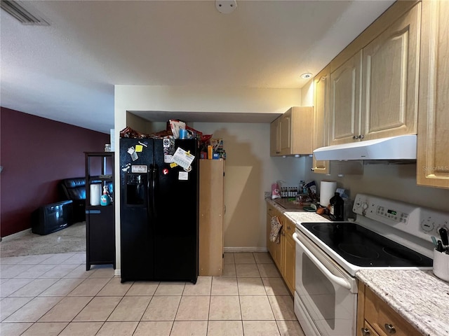 kitchen with black fridge, light tile patterned floors, light brown cabinetry, and white range with electric stovetop