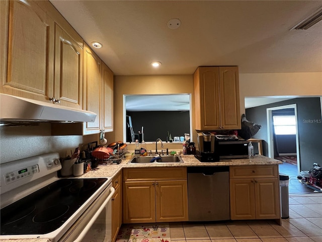 kitchen with light brown cabinetry, sink, light tile patterned floors, and stainless steel appliances