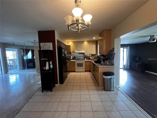 kitchen featuring stainless steel appliances, plenty of natural light, ceiling fan with notable chandelier, and decorative light fixtures