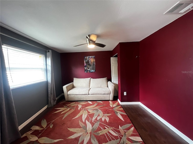 unfurnished living room with dark hardwood / wood-style flooring and ceiling fan